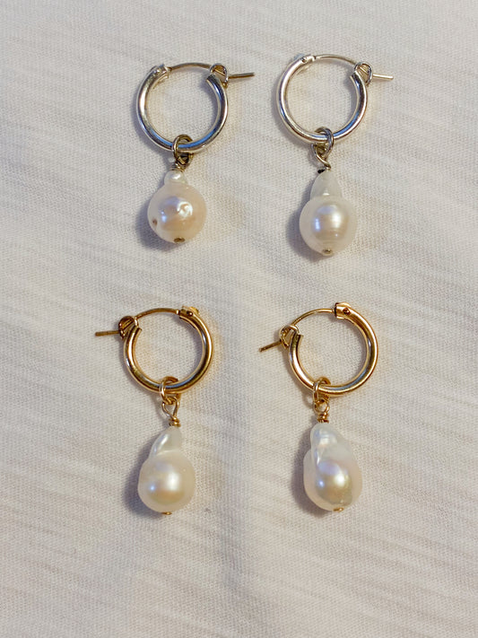 flat lay image of both pairs of pearl drop earrings