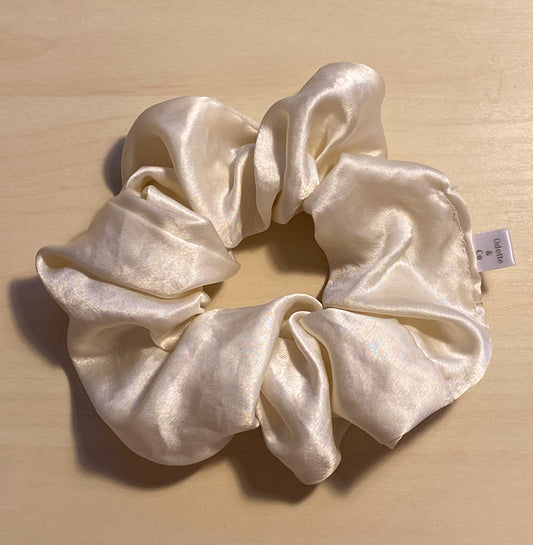 close up flat lay image of french vanilla satin scrunchie 