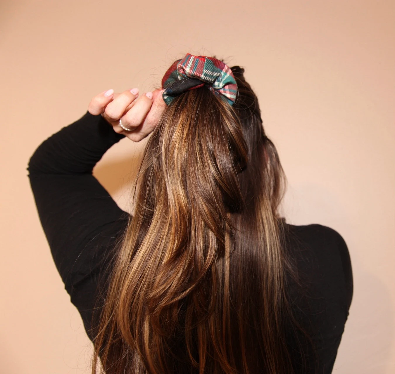 half-up half-down hairstyle with evergreen tartan scrunchie