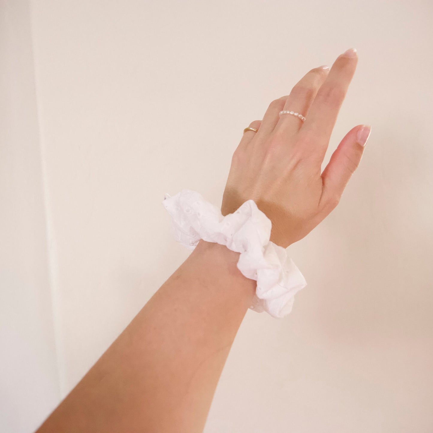 white eyelet cotton scrunchie modeled on wrist