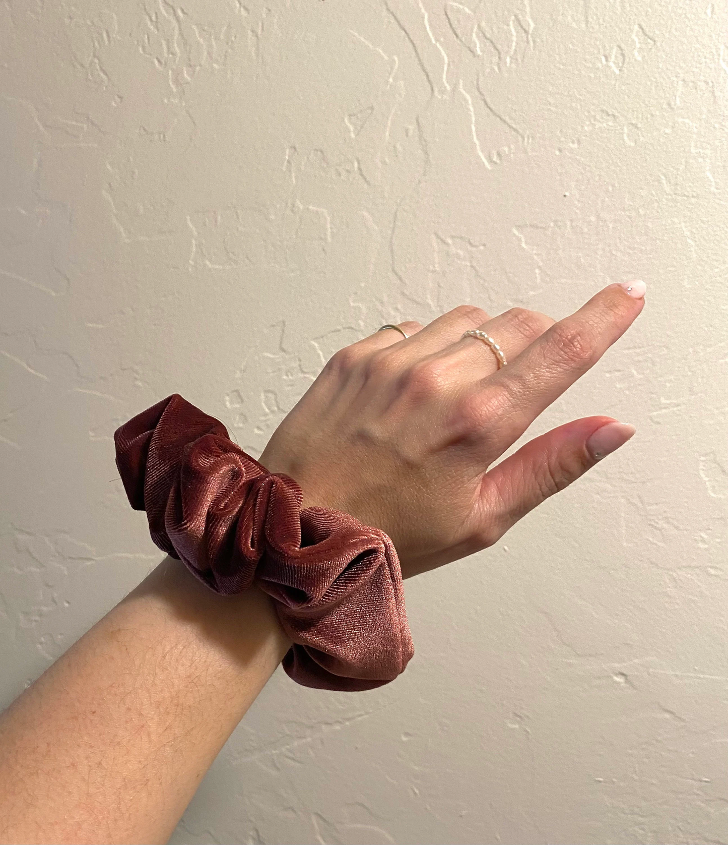 image of winter berry velvet scrunchie modeled on wrist