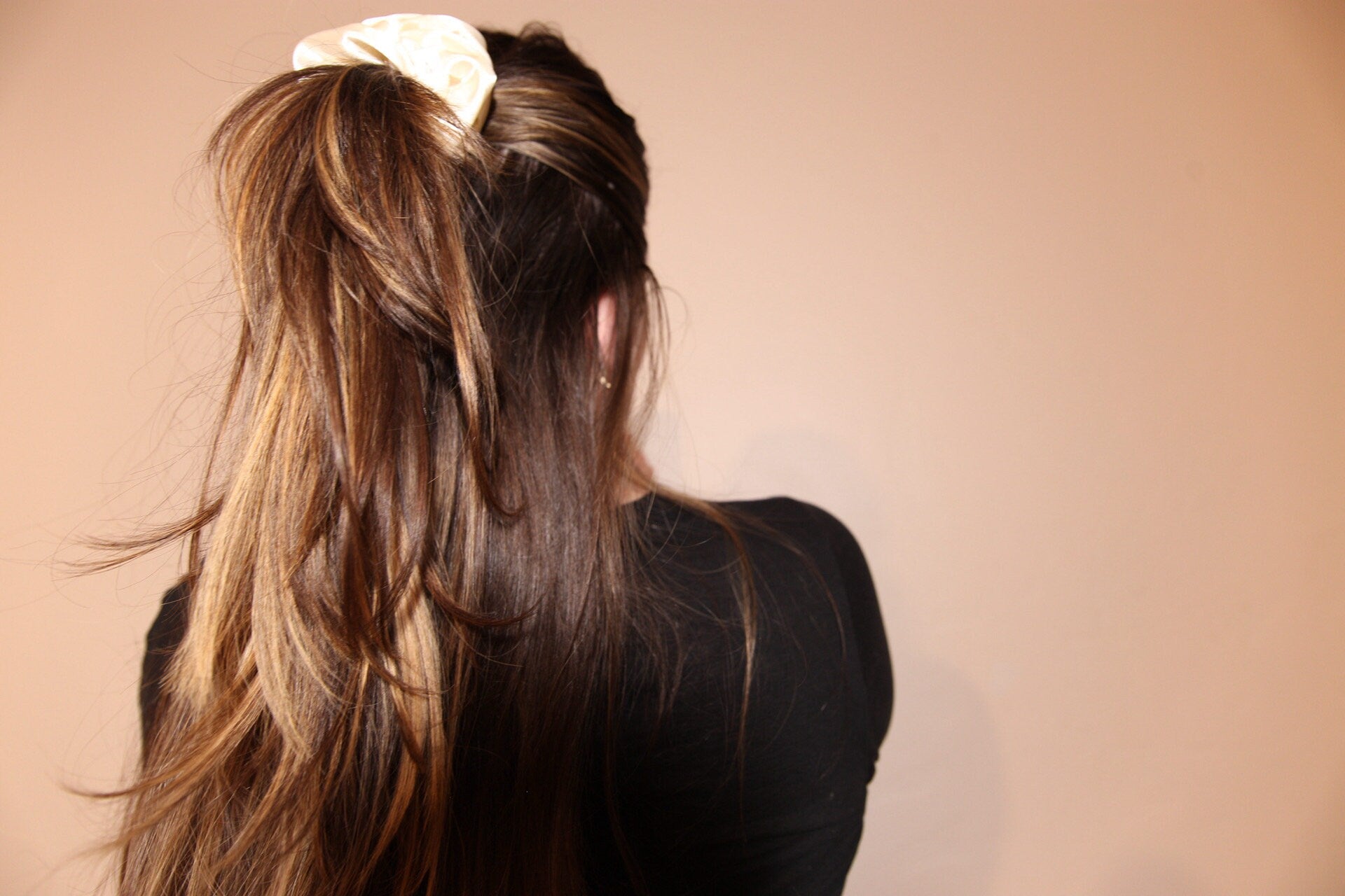 half-up half-down hairstyle wearing french vanilla satin scrunchie 