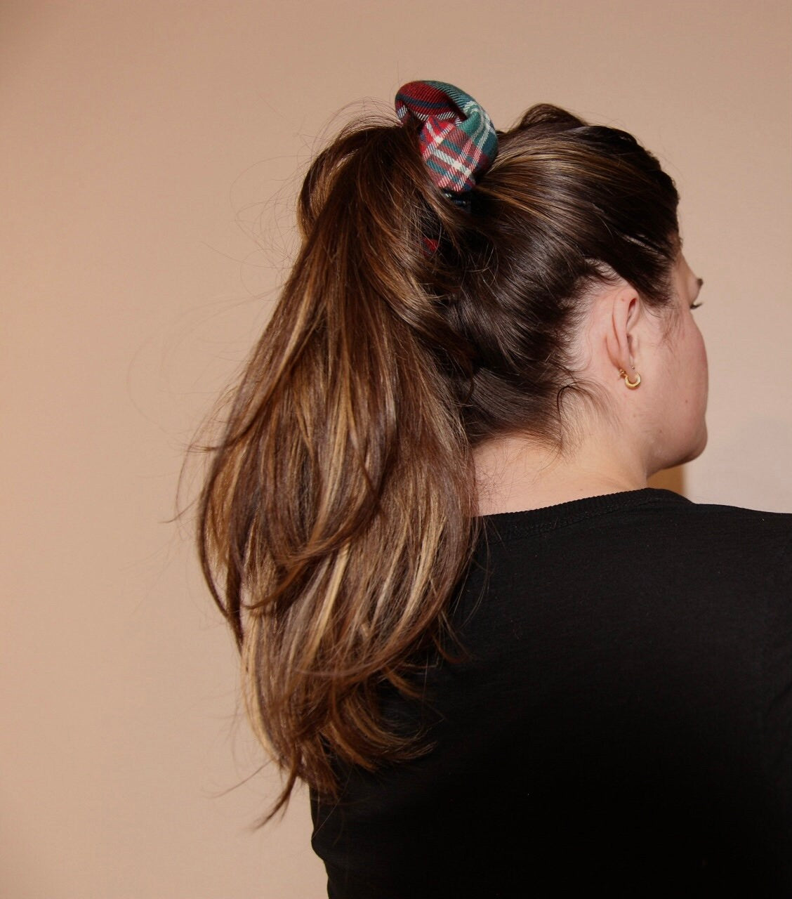 close up of high pony tail featuring evergreen tartan scrunchie 