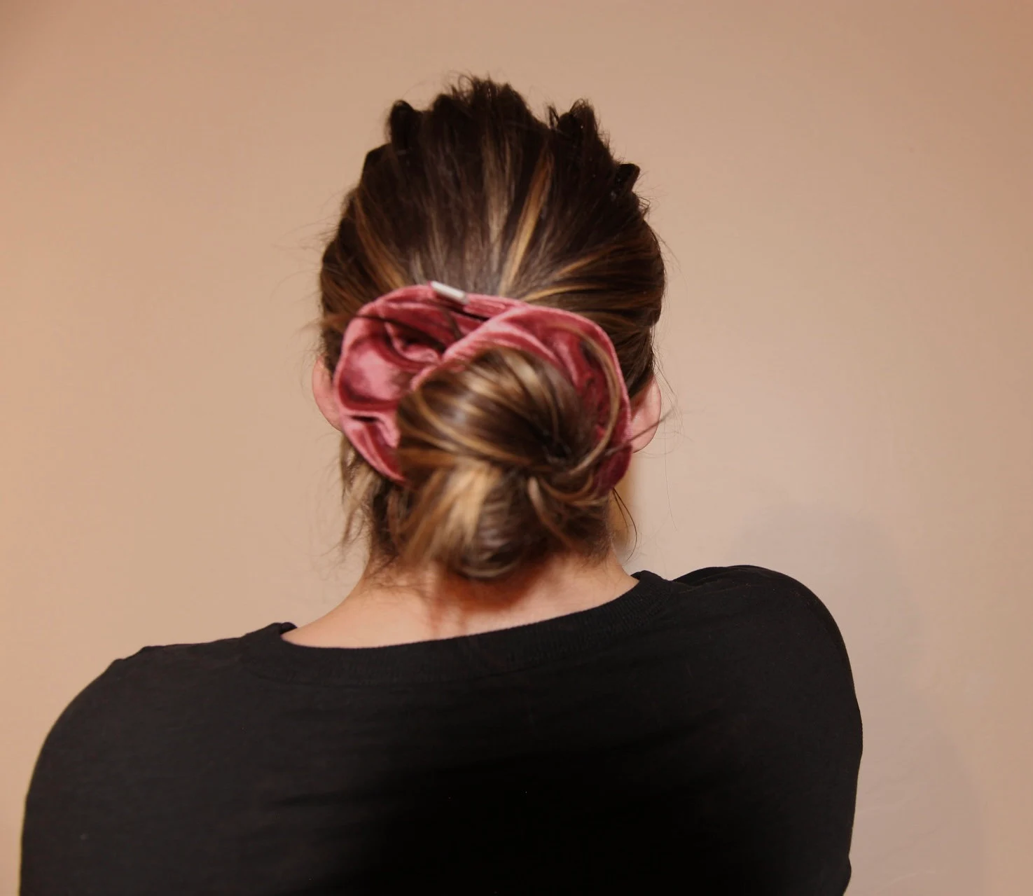 image of winter berry velvet scrunchie wrapped around low bun