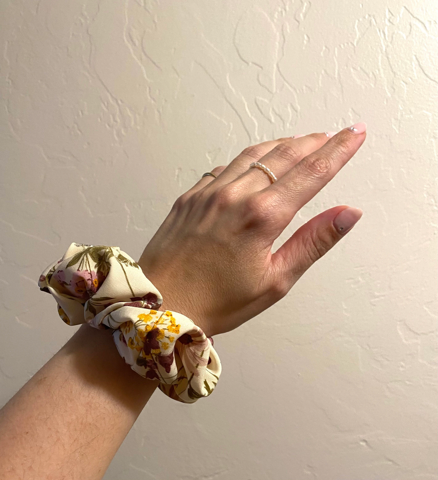 close up image, lovely lavender satin scrunchie modeled on wrist